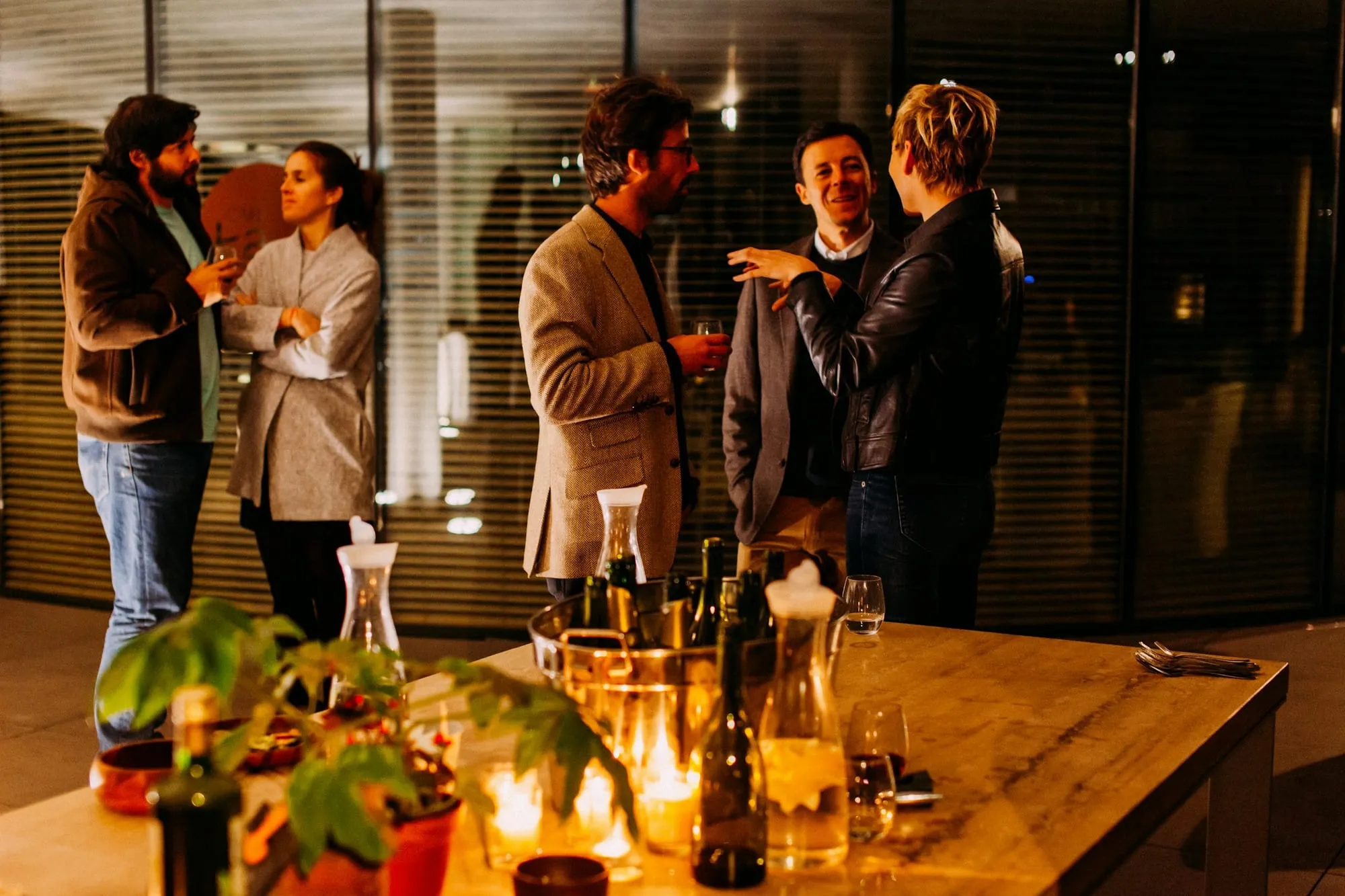 Colleagues at a cocktail around a candlelit table