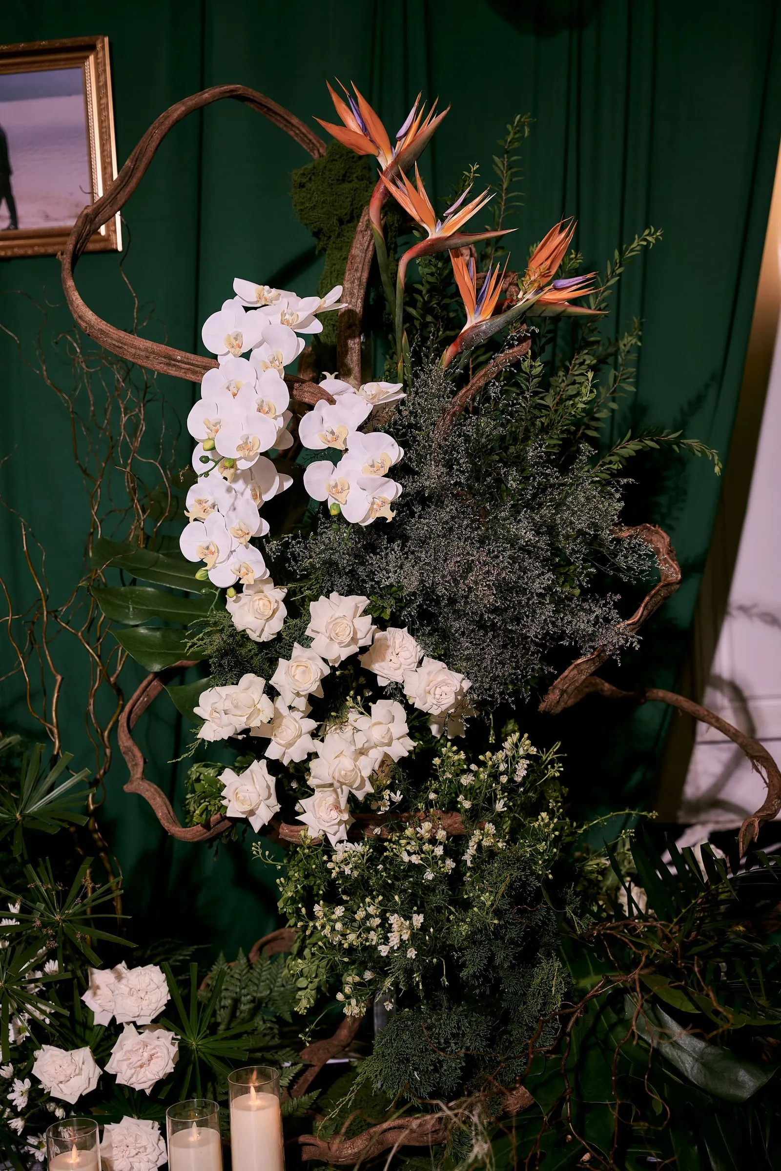 White orchid arrangement against green velvet