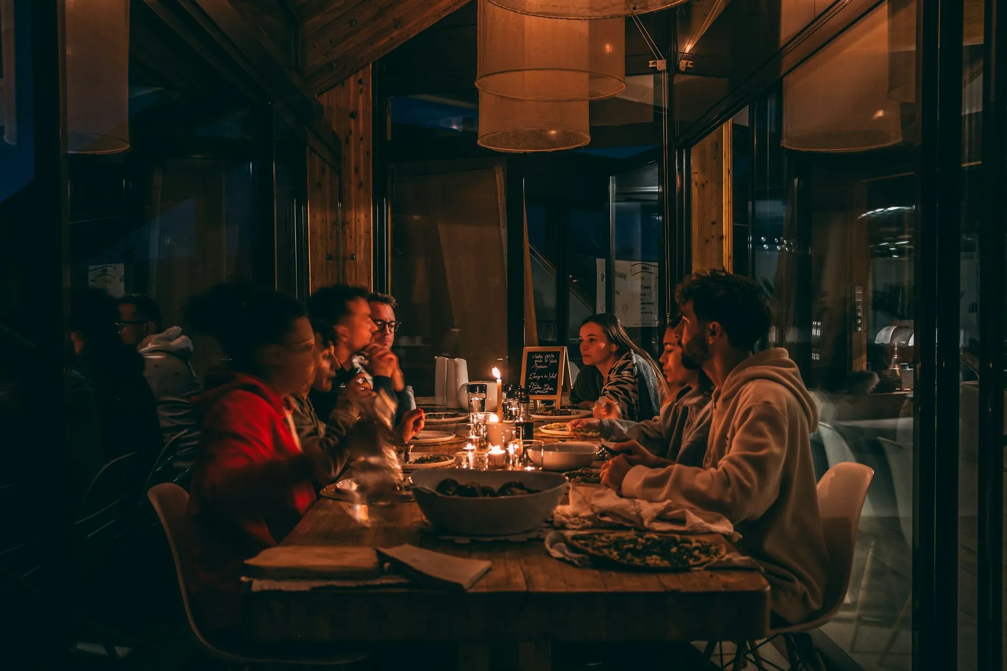 A candlelit team dinner in a restaurant at night