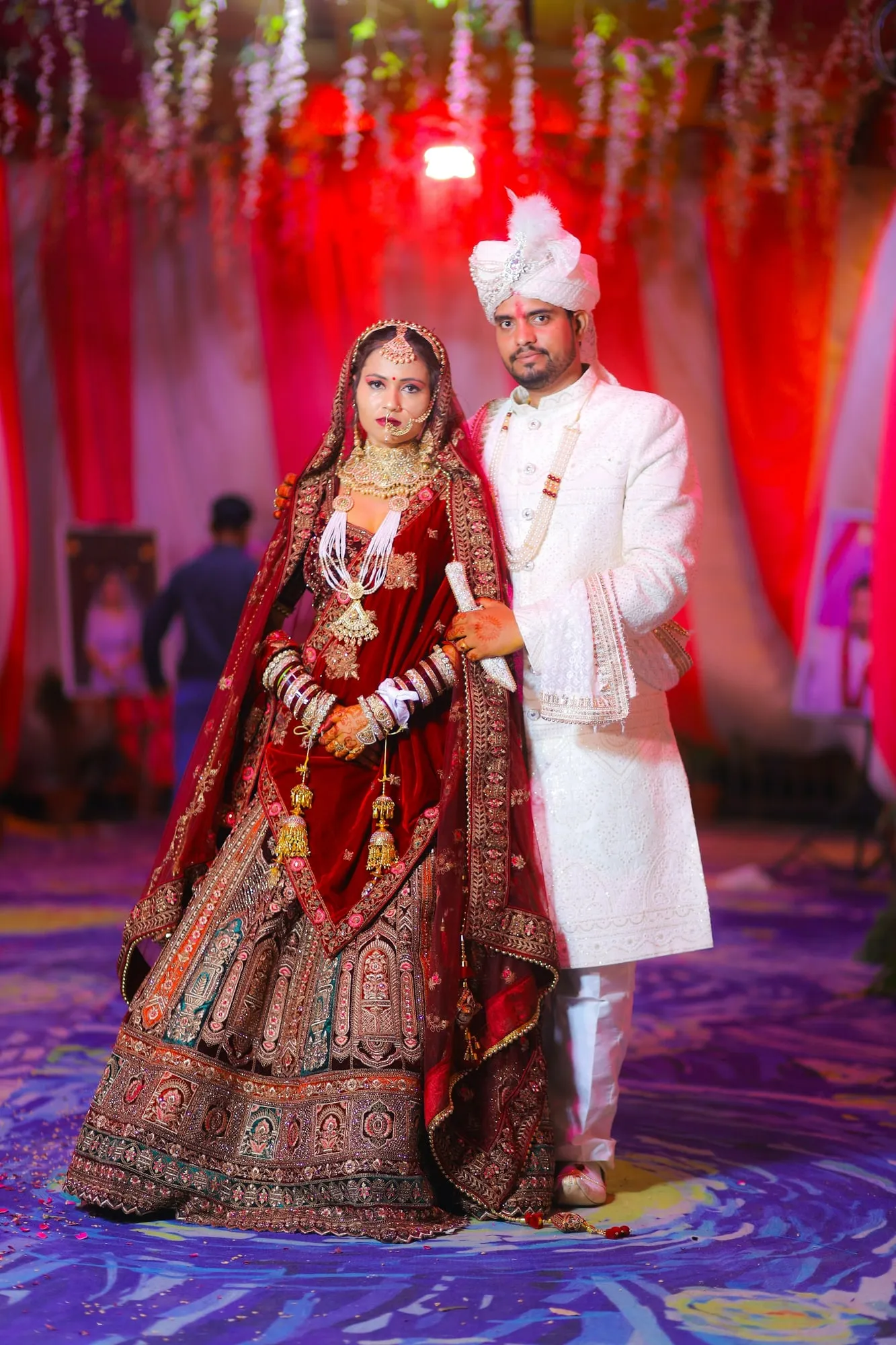 Couple in red and gold Indian ceremonial attire