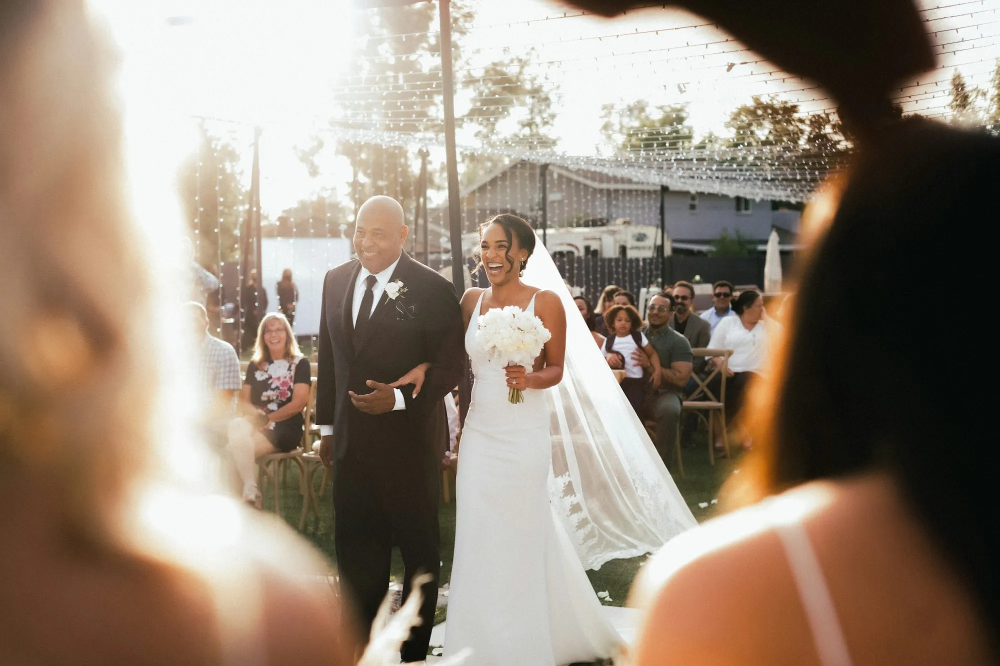 The bride walking down the aisle on her father’s arm