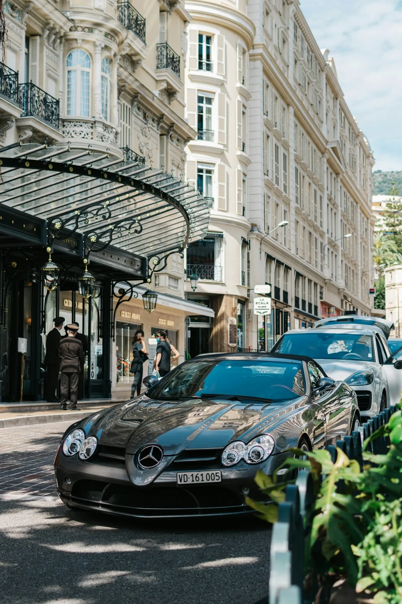 Palace hotel façade in Monaco, a sports car at the entrance