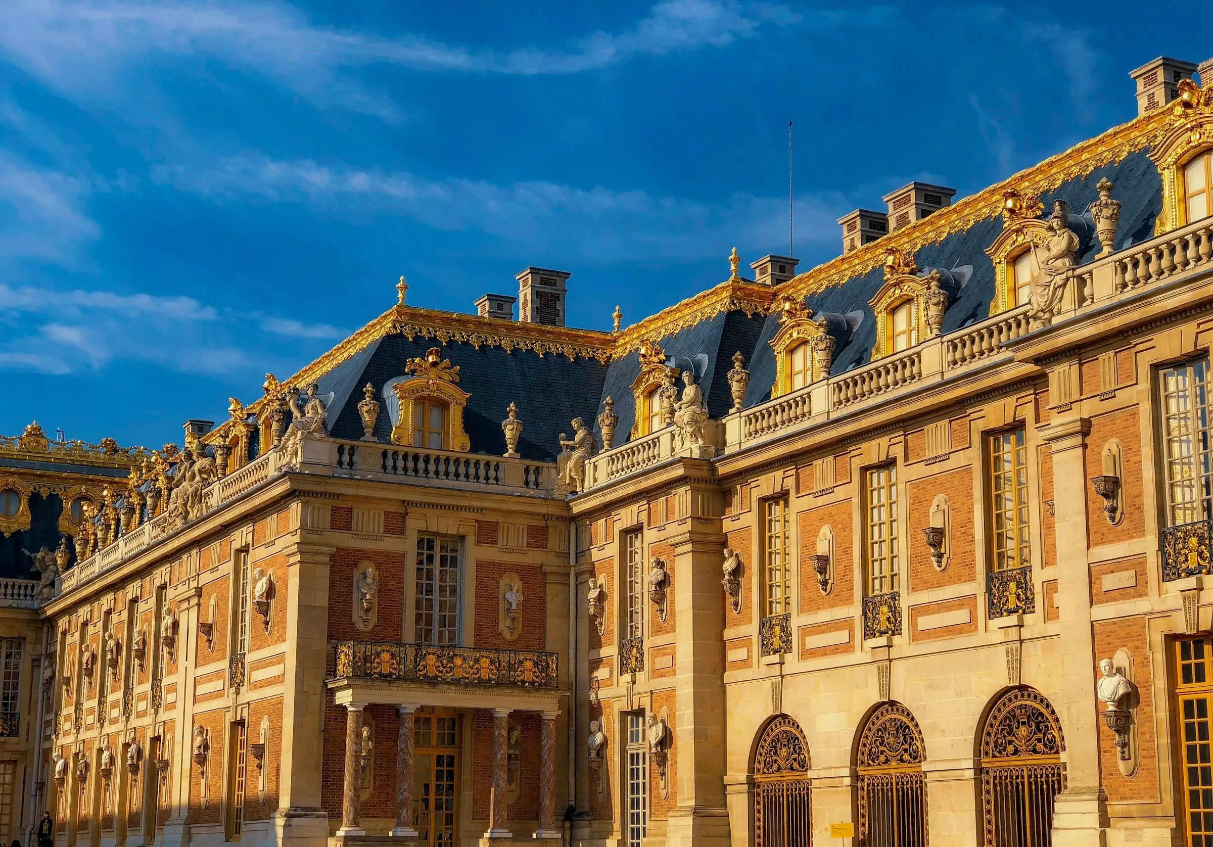 Gilded façade of a classical palace at sunset